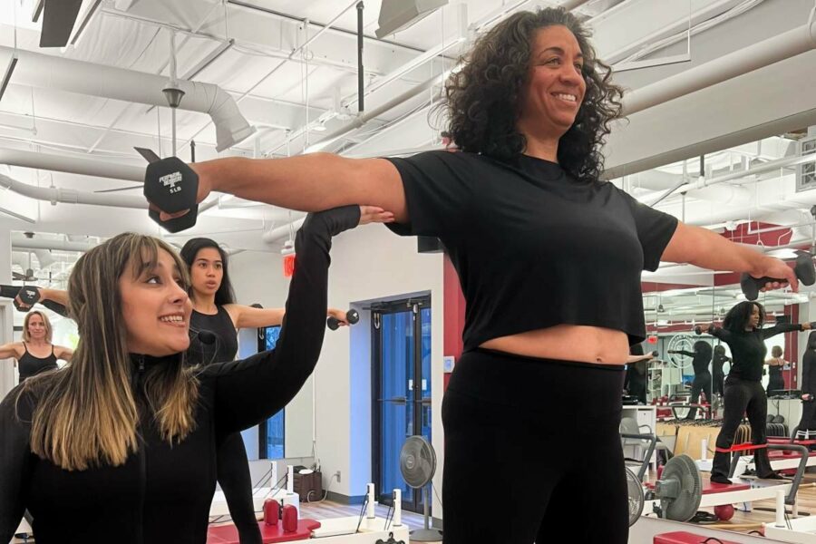 Potomac Pilates Class doing Outer thigh weights exercises