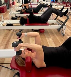 DC Pilates Class doing Skull crush weight exercise