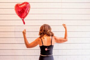 Northern VA pilates instructor with red heart balloon