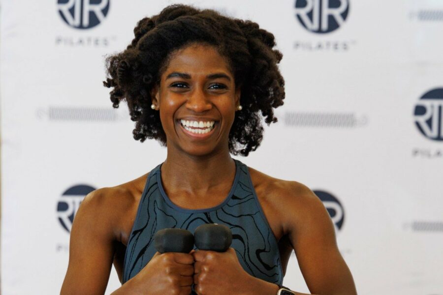 RTR Pilates instructor with weights smiling