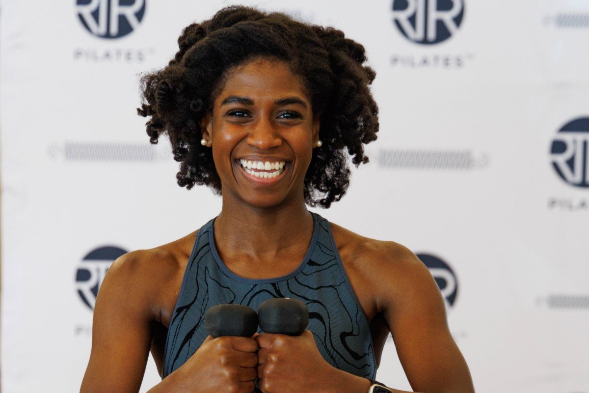 RTR Pilates instructor with weights smiling