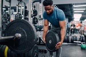 bodybuilder lifting weights in modern gym for intense workout