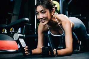fit young woman maintaining a plank position