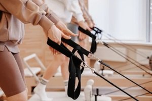 girls with a good stretch in beginners pilates class