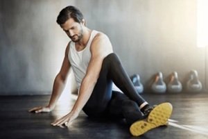 men doing stretching exercises in a gym