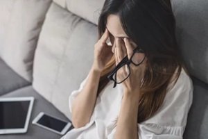 stressed women sitting on sofa