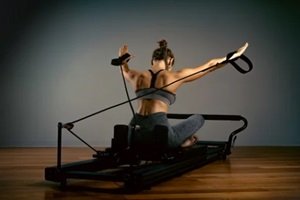 young girl doing pilates exercises with a reformer bed in Washington DC
